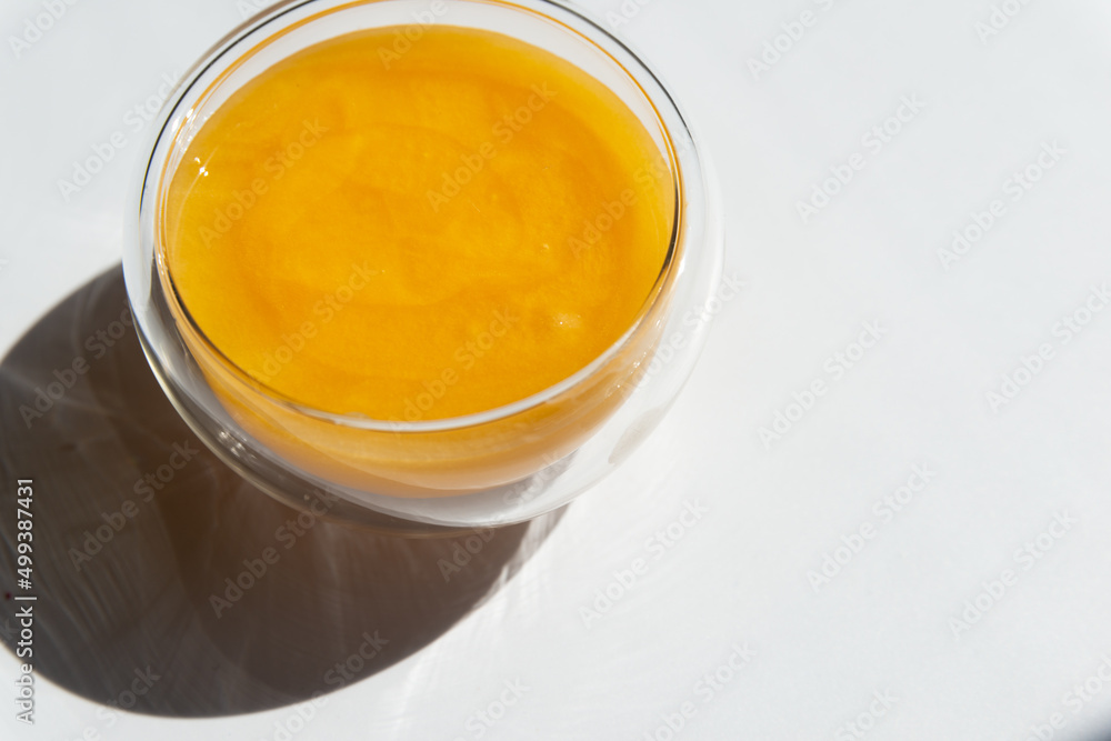 texture of golden honey in a transparent container on a white background free space for text.sunflower honey texture of golden honey in a transparent container on a white background free space for text.sunflower honey