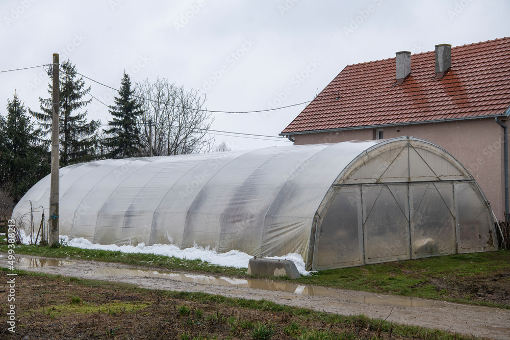 Homemade Old Greenhouse on a small farm next to the house. Rural life in the countryside. Private garden. Healthy food. Homemade Old Greenhouse on a small farm next to the house. Rural life in the countryside. Private garden. Healthy food.