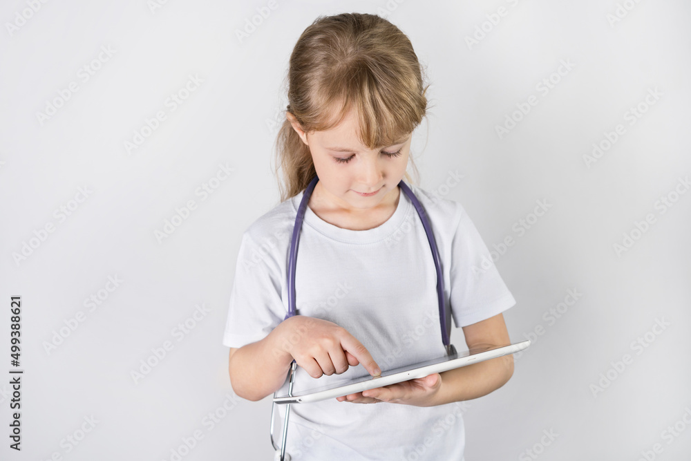 a little girl doctor  with a stethoscope and tablet.  white background. health check concept