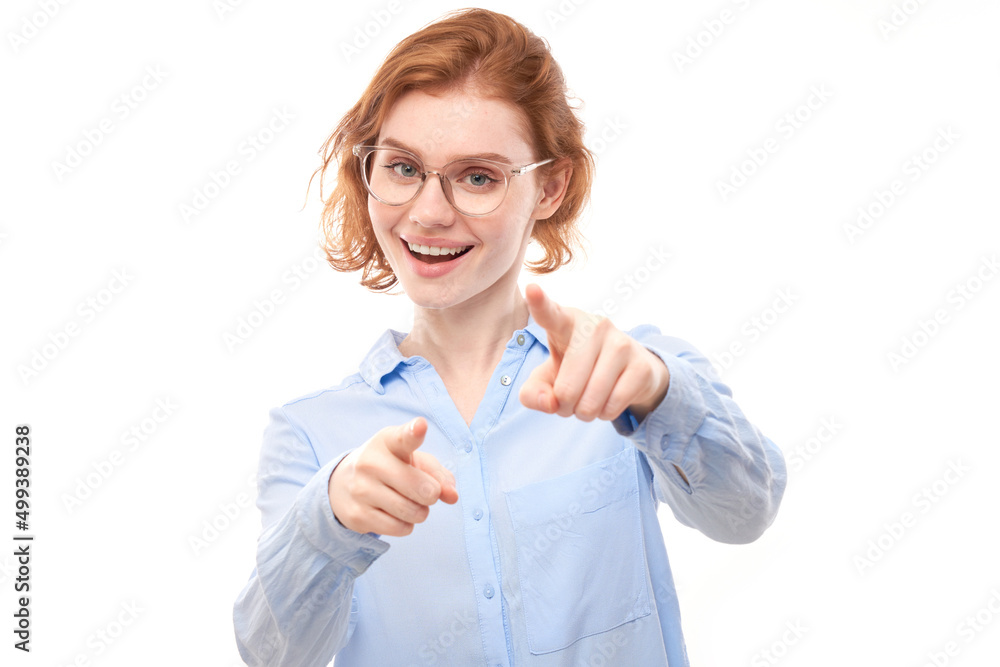 Portrait of friendly redhead girl chooses you, points finger at the camera isolated on white background Portrait of friendly redhead girl chooses you, points finger at the camera isolated on white background