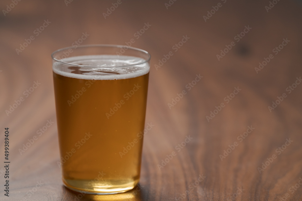 Apple cider in tumbler glass on walnut wood table with copy space Apple cider in tumbler glass on walnut wood table with copy space