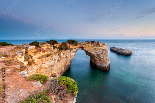 Amazing beach at sunrise. Algarve is located in the south of Portugal and is a vacation destination for many tourists. Your stone arch is an excellent spot for photographers and spearfishing