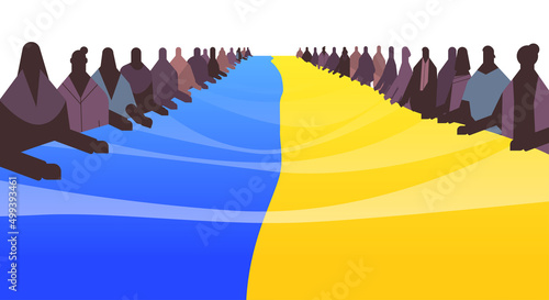 people silhouettes holding Ukrainian flag pray for Ukraine peace save Ukraine from russia stop war concept