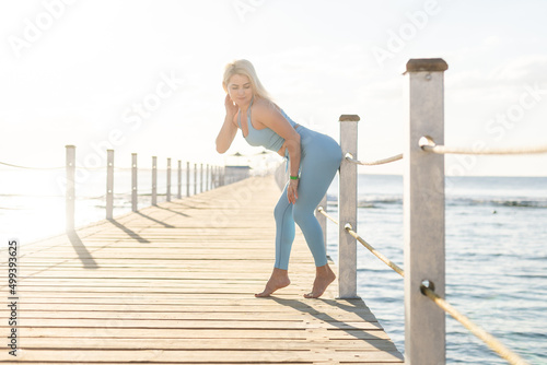 Woman doing yoga exercises by the sea.