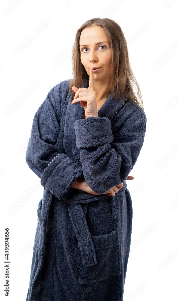 A woman in a bathrobe is standing and looking at the camera. isolated. Life comfort A woman in a bathrobe is standing and looking at the camera. isolated. Life comfort