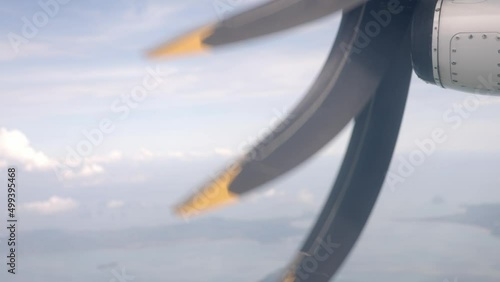 Rotating propeller on a small airplane in the air, clear blue sky with clouds. 4k photo