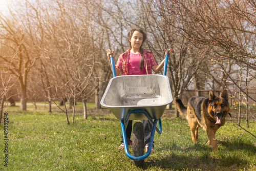 Cute little girl gardening in the backyard. Childhood concept photo