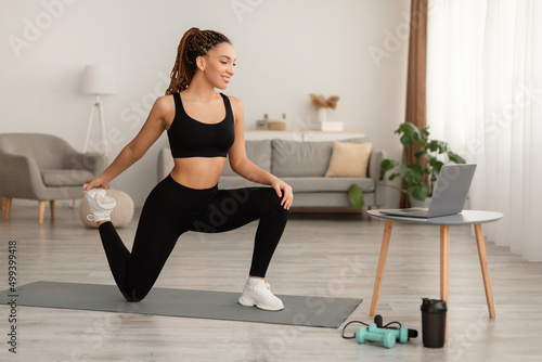 Happy African Lady Doing Hip And Leg Exercises At Home