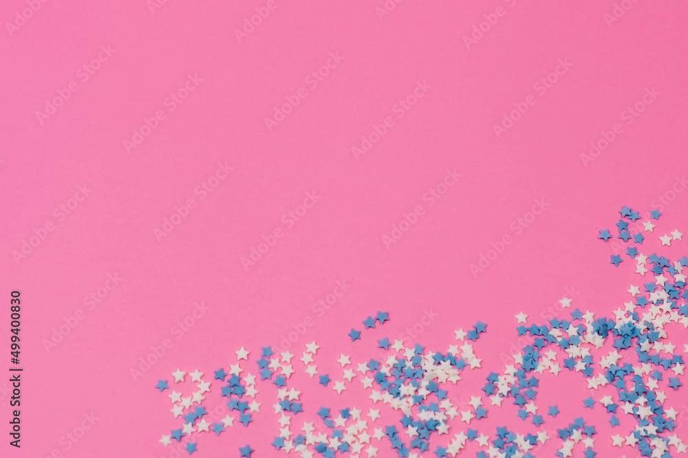 Sugar sprinkle dots, decoration for cake and bakery, as a background. Isolated on pink