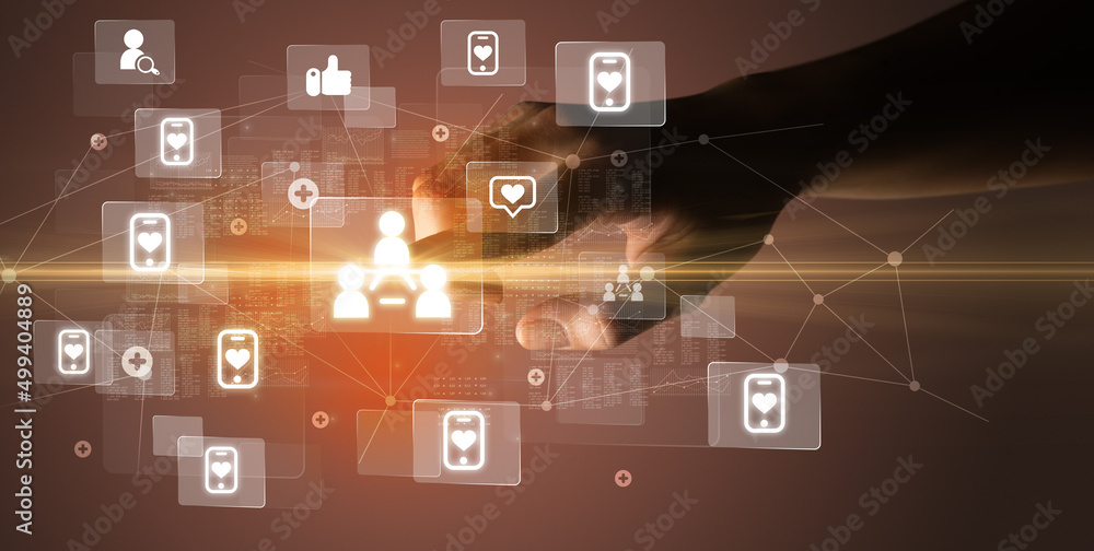 Hand pressing social media multimedia application screen with media icons on futuristic concept Hand pressing social media multimedia application screen with media icons on futuristic concept