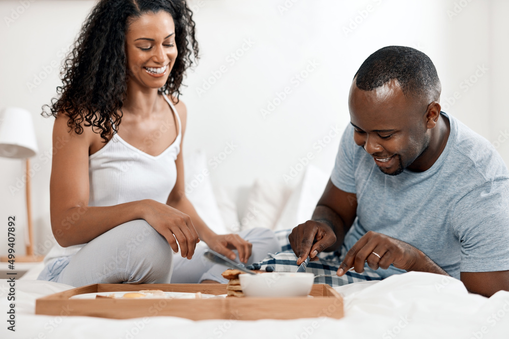 Fototapeta premium Im very impressed with the meal youve made. Shot of a cheerful young couple enjoying breakfast in bed together at home during the day.