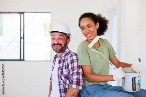 Portrait Cheerful couple young man and black woman smiling during renovation in new apartment