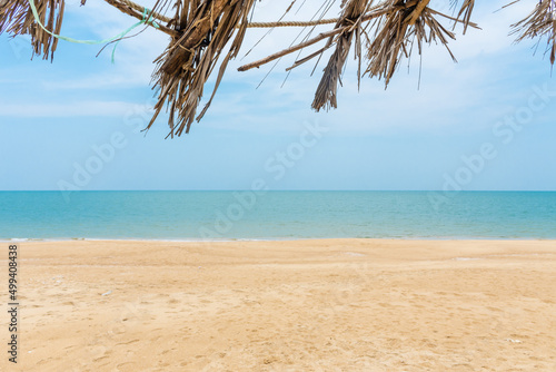 Fototapeta Naklejka Na Ścianę i Meble -  Summer concept. palm roofs, the coconut palms of beach huts decay from the sea breeze during the rainy season. However, this does not detract from the beauty of the sea in summer. nobody, copy space