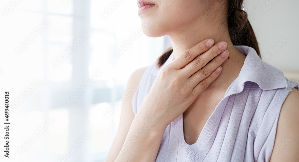 Woman with sore throat inflamed tonsils from influenza symptoms. Healthcare and medical concept Woman with sore throat inflamed tonsils from influenza symptoms. Healthcare and medical concept