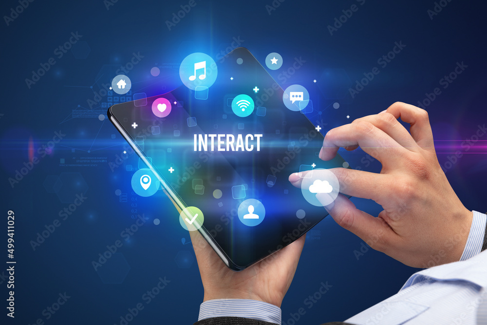 Businessman holding a foldable smartphone Businessman holding a foldable smartphone