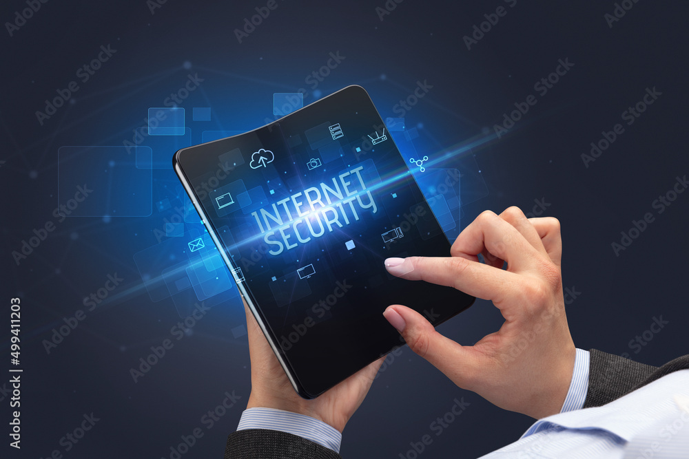 Businessman holding a foldable smartphone, security concept Businessman holding a foldable smartphone, security concept