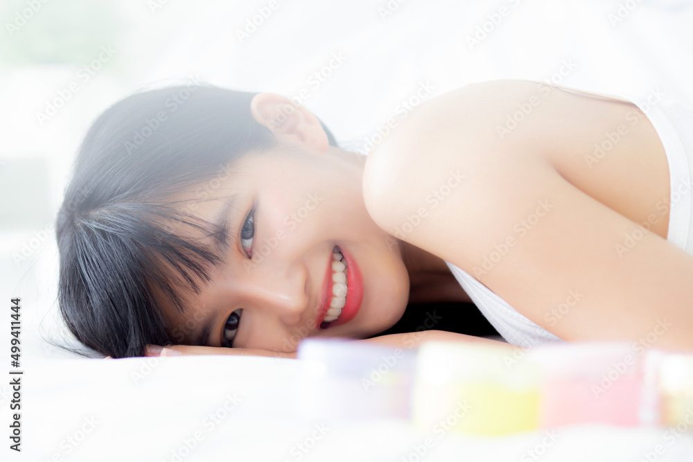 Beautiful of young asian woman smiling and lying on bed at bedroom, beauty of girl with hygiene and healthy, cream and lotion and skin care, cosmetic and makeup, skincare and lifestyles concepts. Beautiful of young asian woman smiling and lying on bed at bedroom, beauty of girl with hygiene and healthy, cream and lotion and skin care, cosmetic and makeup, skincare and lifestyles concepts.