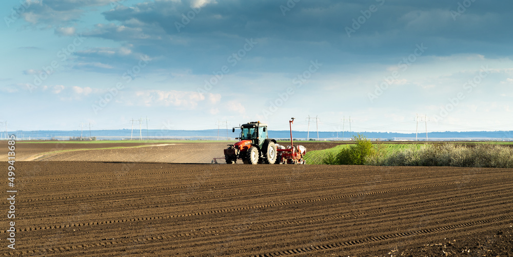 Obraz premium Tractor and seeder for sowing corn