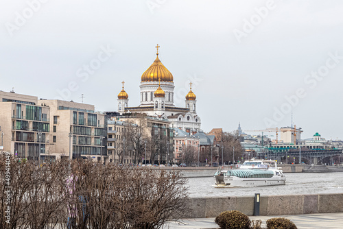 Tourist ship sails along the Moscow River against the background of the Cathedral of Christ the Savior