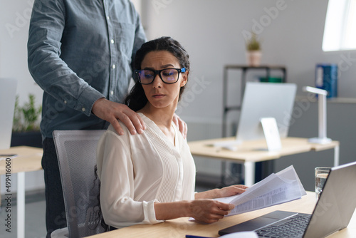 Beautiful young woman being victim of sexual harassment at workplace, copy space