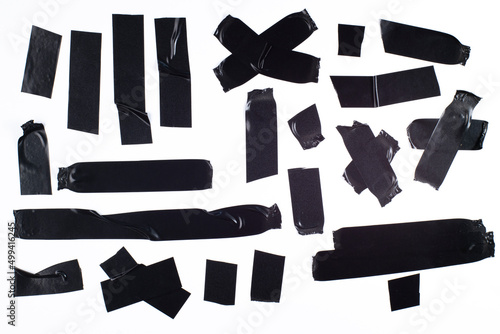 Torn off pieces of black insulating tape on white isolated, different shapes of pieces of tape, high resolution.