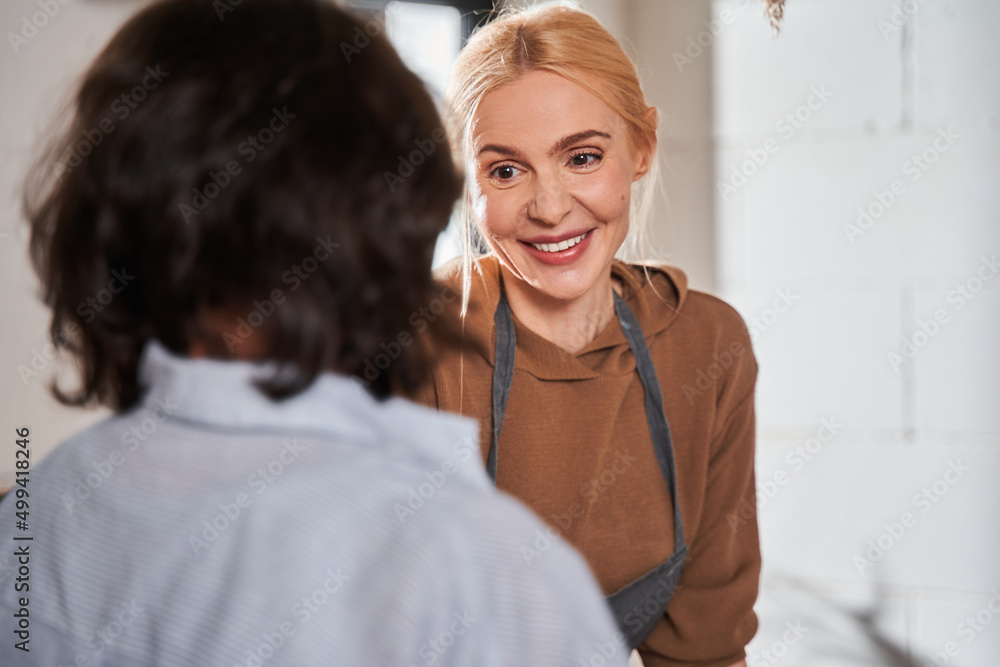 Fototapeta premium Caucasian woman talking with her senior student after workshop