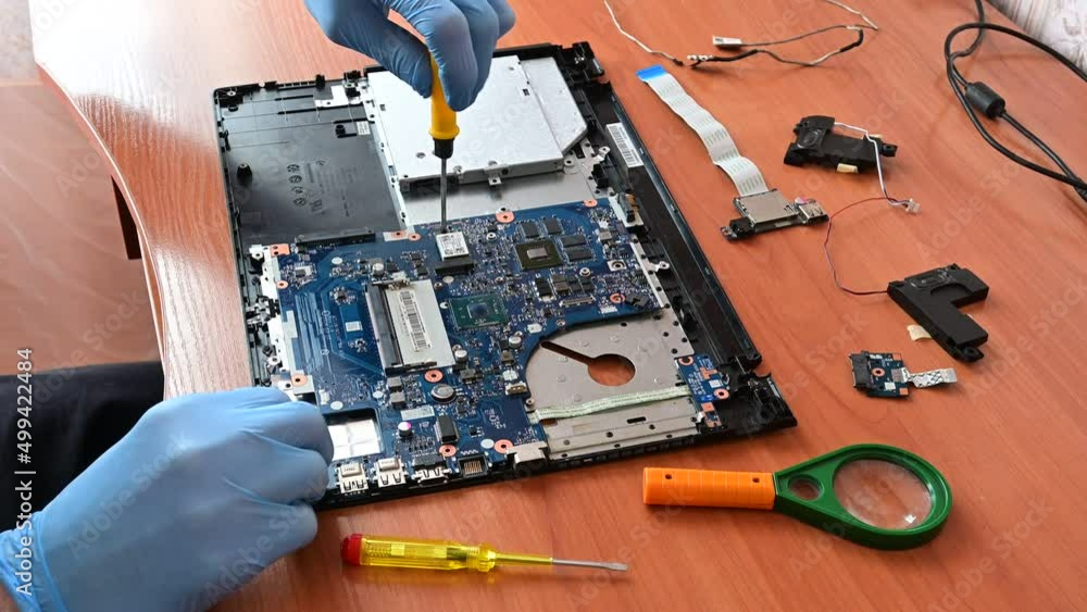 laptop repair. master repairs a disassembled laptop. professional ...