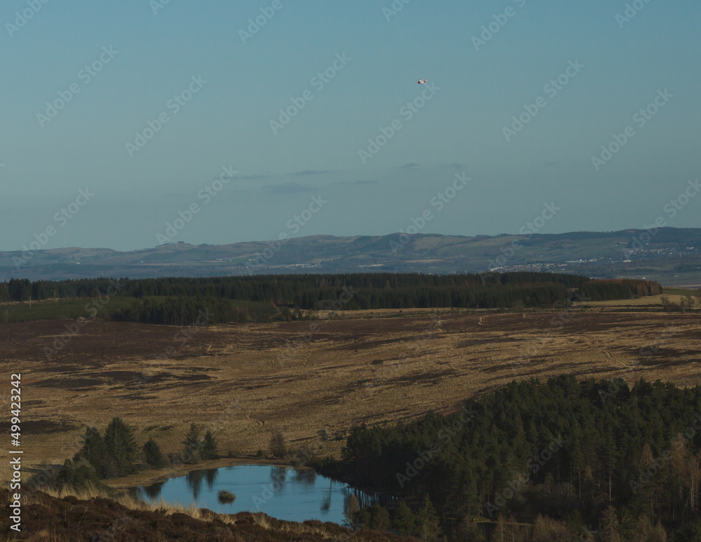 Fototapeta premium Helicopter flying over the lake.