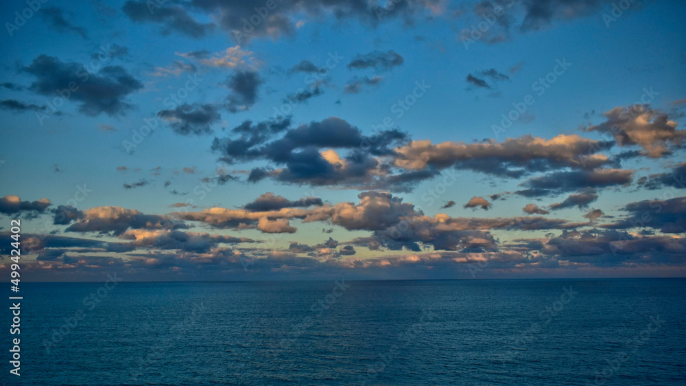 Sunset tints clouds to the east over the Atlantic Ocean