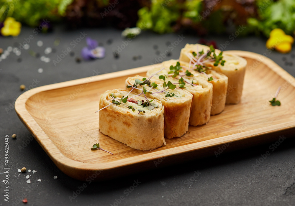 Snacks of pita bread with cheese and tomatoes. Variety mix of small sandwiches on dark background. Photo for restaurant menu Snacks of pita bread with cheese and tomatoes. Variety mix of small sandwiches on dark background. Photo for restaurant menu