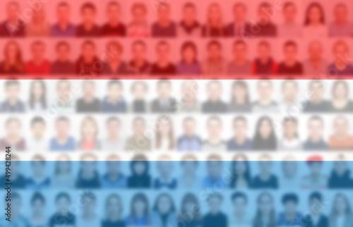 Portraits of many people on the background of the flag of the Netherlands. The concept of the population and demographic state of the country.