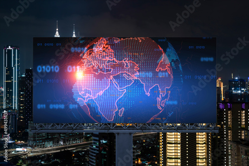 Hologram of Earth planet map on billboard over night panoramic cityscape of Kuala Lumpur, Malaysia, Asia. The concept of international companies in KL. Globe