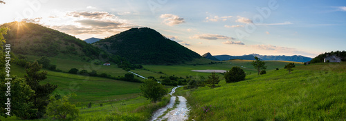 Sunset dramatic sky over Montelago highlands, Marche, Italy. Unique hill and mountain green landscape. photo