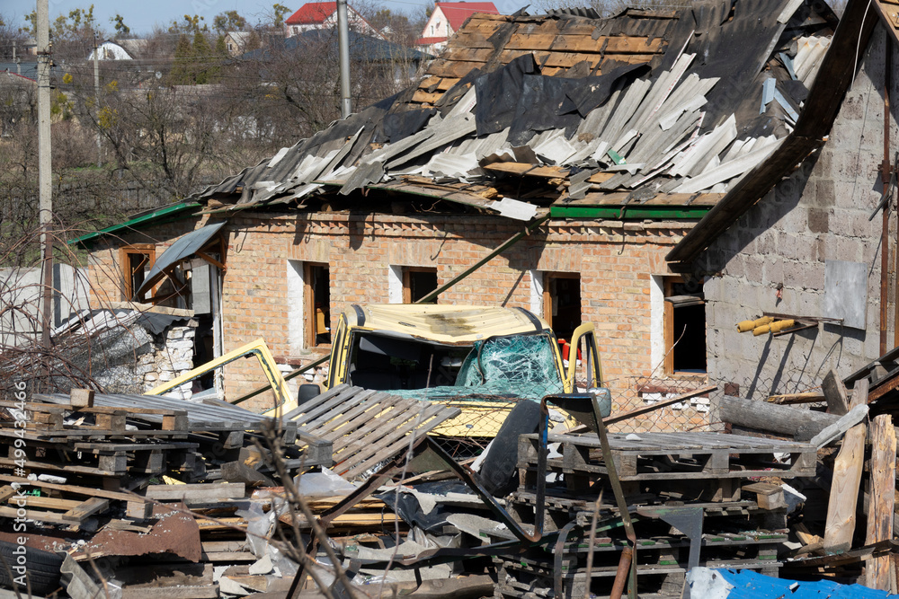 Russia invaded Ukraine. Ukrainian village after being hit by a bomb. Destroyed house, car. Ukrainian village after the bombing. Destruction of residential buildings.