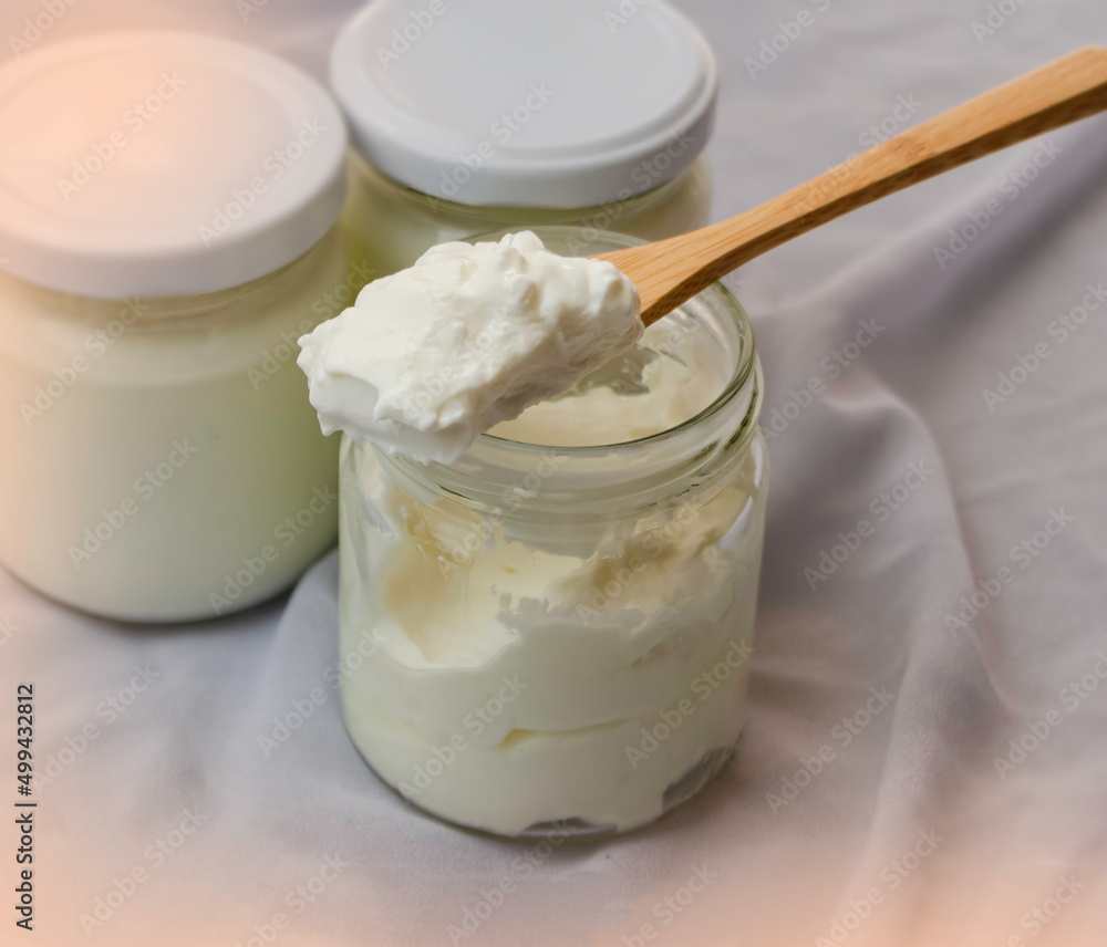 In selective focus of yoghurt in wooden spoon In selective focus of yoghurt in wooden spoon