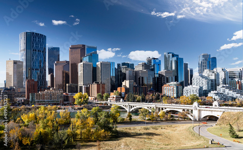 Downtown Calgary skyline in fall colours with office buildings and popular landmarks including the Center street Bridge and Riley park in Alberta Canada.