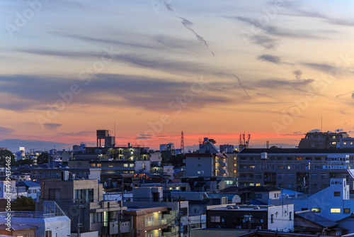Sunset and clouds over lights of sprawling residential neighborhood
