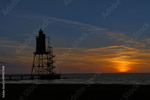 scenic view of a lighthouse at sunset