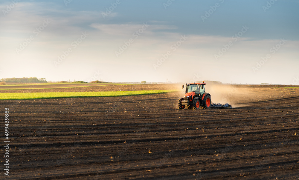 Obraz premium Farmer preparing his field in a tractor