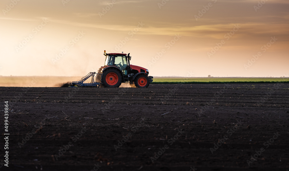 Farmer preparing his field in a tractor Farmer preparing his field in a tractor