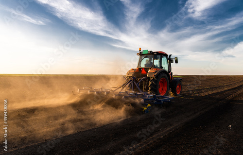 Fototapeta Naklejka Na Ścianę i Meble -  Farmer preparing his field in a tractor