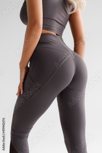 Fitness model in leggings with beautiful buttocks. Sporty booty photo