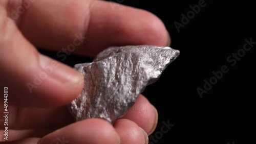 Miners hold in their hands platinum or silver or rare earth minerals found in the mine for inspection and consideration	