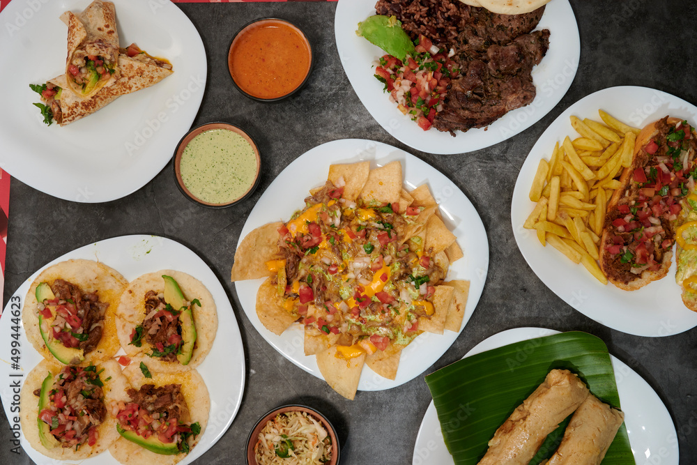 assorted of mexican food with fajitas, chili con carne and nachos with avocado, beef and cheese assorted of mexican food with fajitas, chili con carne and nachos with avocado, beef and cheese