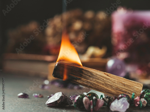Palo Santo, holy sacred tree stick, burning with aroma smoke. Esoteric life balance, good energy concept. Healing energy with crystals and smoke. © Gulsina