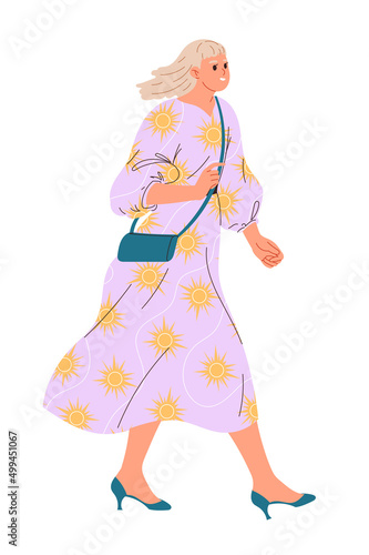 Stylish young walking woman in a loose light dress