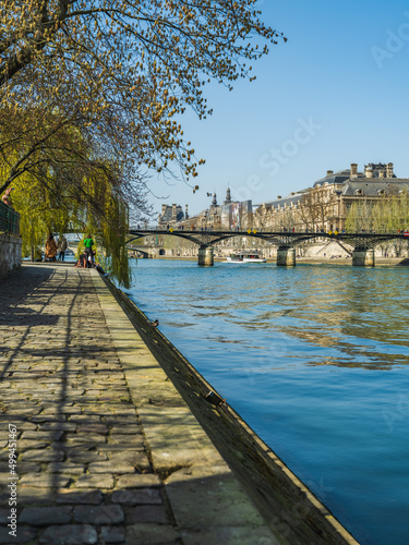 Romantic pedestrian walkway on the Seine river bank in Paris