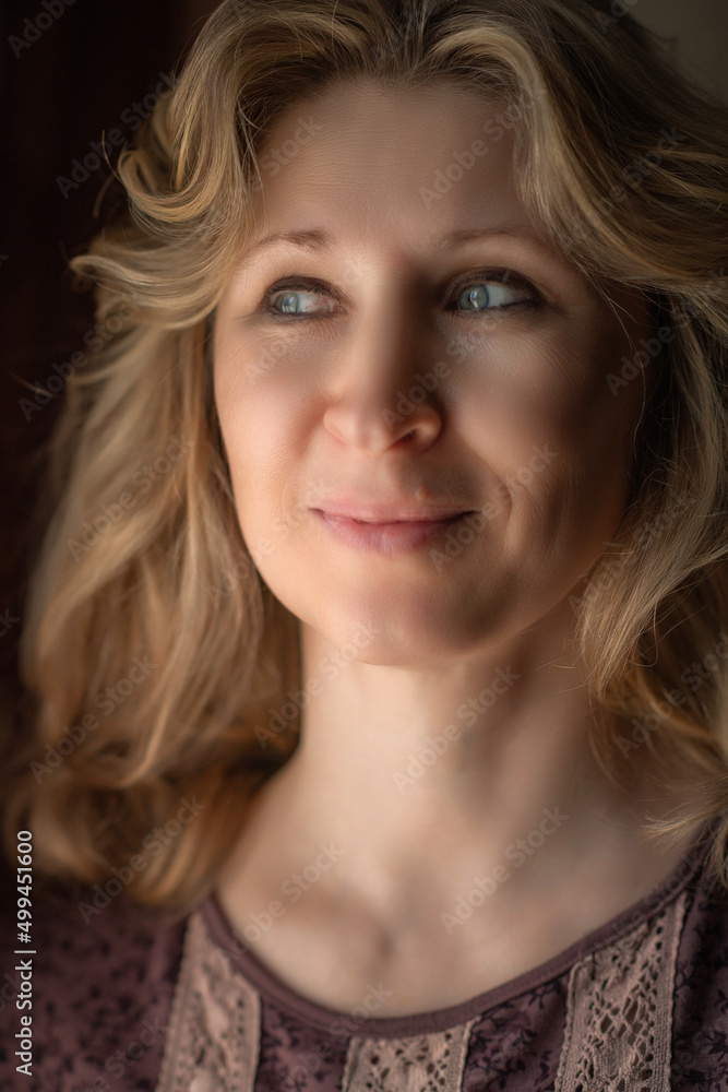 Close-up portrait of a beautiful fair-haired middle-aged woman. Close-up portrait of a beautiful fair-haired middle-aged woman.