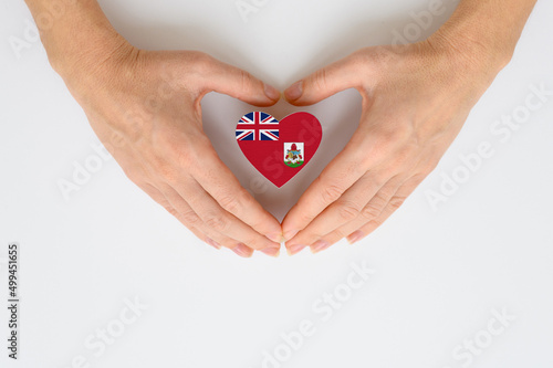 The national flag of Bermuda in female hands.