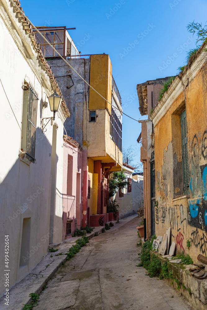 ATHENS, GREECE - DECEMBER 20, 2021: Traditional houses and small streets at Anaphiotika district near Acropolis Hill.